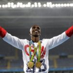 FILE Britain’s Mo Farah celebrates winning the gold medal, in the men’s 5000-meter medals ceremony, during the athletics competitions of the 2016 Summer Olympics at the Olympic stadium in Rio de Janeiro, Brazil, Saturday, Aug. 20, 2016. Four-time Olympic champion Mo Farah has disclosed he was brought into Britain illegally from Djibouti under the name of another child. The British athlete made the revelation in a BBC documentary. (AP Photo/Jae C. Hong, File)
