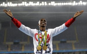 FILE Britain’s Mo Farah celebrates winning the gold medal, in the men’s 5000-meter medals ceremony, during the athletics competitions of the 2016 Summer Olympics at the Olympic stadium in Rio de Janeiro, Brazil, Saturday, Aug. 20, 2016. Four-time Olympic champion Mo Farah has disclosed he was brought into Britain illegally from Djibouti under the name of another child. The British athlete made the revelation in a BBC documentary. (AP Photo/Jae C. Hong, File)