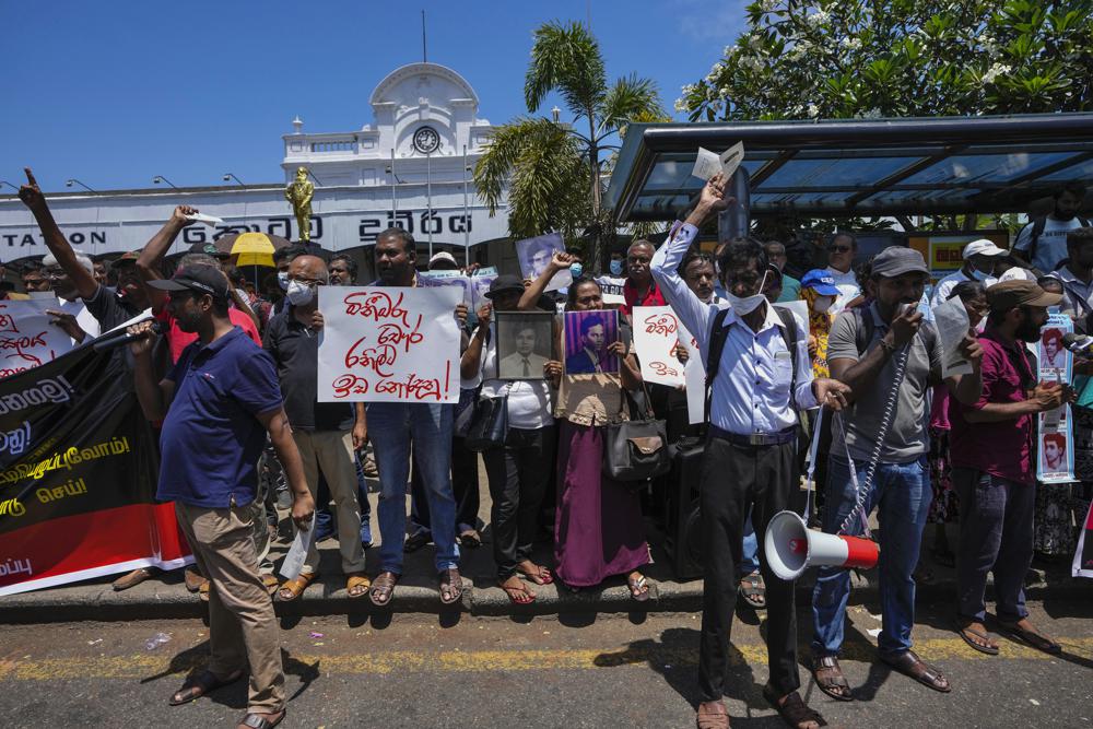 Trade Union activists and civil society members shout slogans against Acting President and Prime Minister Ranil Wickremesinghe as lawmakers prepare to elect a new president in Colombo, Sri Lanka, Tuesday, July 19, 2022. The protestors demanded Wickremesinghe be ousted and prevented from being elected as the successor to Gotabaya Rajapaksa who fled the country last week. (AP Photo/Eranga Jayawardena)