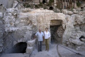 Hebrew University archaeologists Dr. Oren Gutfeld, left, and Michal Haber, pose for a portrait at the site of a Jewish ritual bath or mikveh, discovered near the Western Wall in the Old City of Jerusalem, Sunday, July 17, 2022. An excavation to build an accessible elevator from the Jewish Quarter to the Western Wall near the Temple Mount by the Hebrew University of Jerusalem’s Institute of Archaeology has unearthed the mikveh that dates back to the 1st Century CE. (AP Photo/Maya Alleruzzo)