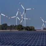 File – Wind turbines turn behind a solar farm in Rapshagen, Germany, Thursday, Oct. 28, 2021. German lawmakers were poised Thursday to approve a major package of reforms aimed at boosting the production of renewable power, as Chancellor Olaf Scholz warned that the country has for too long relied on energy supplies from Russia. (AP Photo/Michael Sohn, File)