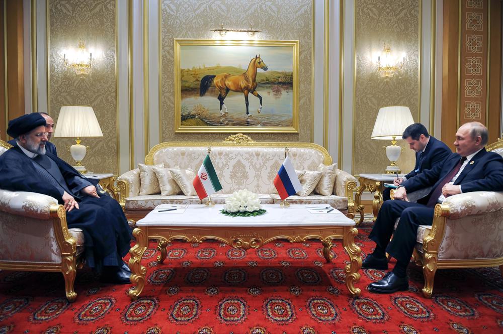 FILE – Russian President Vladimir Putin, right, speaks to Iran’s President Ebrahim Raisi on the sideline of the summit of Caspian Sea littoral states in Ashgabat, Turkmenistan, on June 29, 2022. Putin’s visit to Iran starting Tuesday, July 19, is intended to deepen ties with regional heavyweights as part of Moscow’s challenge to the United States and Europe amid its grinding campaign in Ukraine. (Mikhail Klimentyev, Sputnik, Kremlin Pool Photo via AP, File)