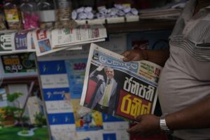 A man holds a newspaper with news of Ranil Wickremesinghe’s election in Colombo, Sri Lanka, Thursday, July 21, 2022. Sri Lanka’s prime minister was elected president Wednesday by lawmakers who opted for a seasoned, veteran leader to lead the country out of economic collapse, despite widespread public opposition. (AP Photo/Rafiq Maqbool)