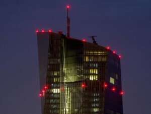 FILE – Red lights shine on top of the European Central Bank in Frankfurt, Germany, Sept. 7, 2021. The European Central Bank is behind the U.S. Federal Reserve and other central banks around the world in combating surging inflation. It’s looking to catch up as it raises interest rates for the first time in 11 years Thursday July 21, 2022, but it also faces a more serious threat of recession than other places amid an energy crisis provoked by Russia’s war in Ukraine. (AP Photo/Michael Probst, File)