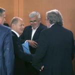 German Chancellor Olaf Scholz, second left, greets representatives of the German unions and the German employers for a ‘Concerted Action’ meeting at the Chancellery in Berlin, Germany, Monday, July 4, 2022. (AP Photo/Michael Sohn)