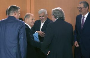 German Chancellor Olaf Scholz, second left, greets representatives of the German unions and the German employers for a ‘Concerted Action’ meeting at the Chancellery in Berlin, Germany, Monday, July 4, 2022. (AP Photo/Michael Sohn)