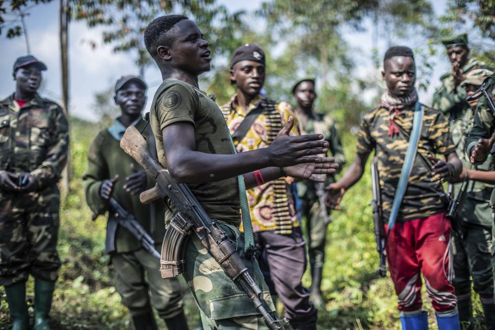 Armed militiamen gather near Rutshuru, 70 kms (45 miles) north of Goma, Democratic Republic of Congo,Wednesday June 22, 2022. Earlier in the week, East Africa’s leaders have responded to the threat of war between Rwanda and Congo by instructing a new regional force to deploy in eastern Congo and ordering an immediate cease-fire. A statement after the meeting in Kenya’s capital does not give details on the date of deployment of the force or its composition. (AP Photo/Moses Sawasawa)