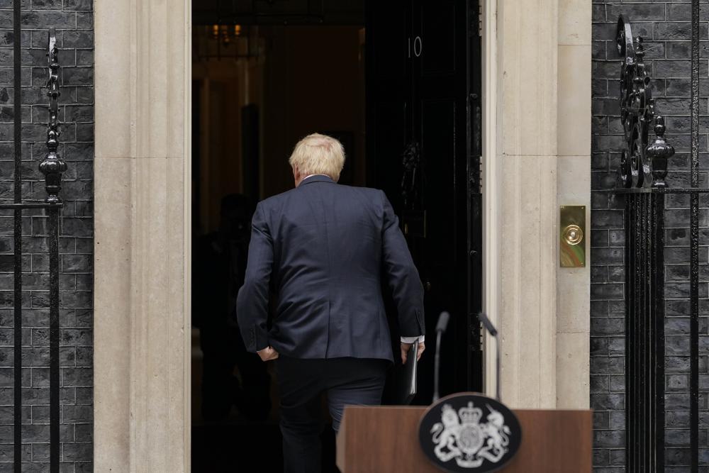 FILE – Prime Minister Boris Johnson enters 10 Downing Street, after his reading a resignation statement in London, July 7, 2022. Outgoing U.K. Prime Minister Boris Johnson has been the bane of Brussels for many years, from his days stoking anti-European Union sentiment with exaggerated newspaper stories to his populist campaign leading Britain out of the bloc and reneging on the post-Brexit trade deal he himself signed. (AP Photo/Alberto Pezzali, file)