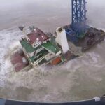 FILE – In this image released by Hong Kong Government Flying Service, a helicopter with rescue crew members approaches a sinking ship in the South China Sea, 300 kilometers (186 miles) south of Hong Kong on July 2, 2022, as Typhoon Chaba was moving in the area. A fourth crew member has been rescued Monday, July 4, 2022 after the typhoon sunk the engineering vessel earlier this week, according to a Chinese state broadcaster. (Hong Kong Government Flying Service via AP)