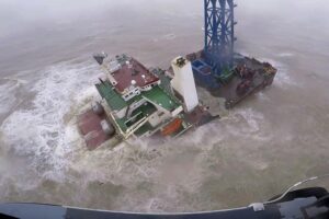 FILE – In this image released by Hong Kong Government Flying Service, a helicopter with rescue crew members approaches a sinking ship in the South China Sea, 300 kilometers (186 miles) south of Hong Kong on July 2, 2022, as Typhoon Chaba was moving in the area. A fourth crew member has been rescued Monday, July 4, 2022 after the typhoon sunk the engineering vessel earlier this week, according to a Chinese state broadcaster. (Hong Kong Government Flying Service via AP)