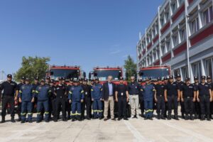 Climate Crisis and Civil Protection Minister Christos Stylianides, center, poses with Romanian and Greek firefighters during a ceremony, in Athens, on Saturday, July 2, 2022. Twenty eight Romanian firefighters, the first of more than 200 firefighters from other European countries that will help their Greek colleagues in fighting wildfires, were welcomed by Climate Crisis and Civil Protection Minister Christos Stylianides and the leadership of Greece’s Fire Service. (AP Photo/Yorgos Karahalis)