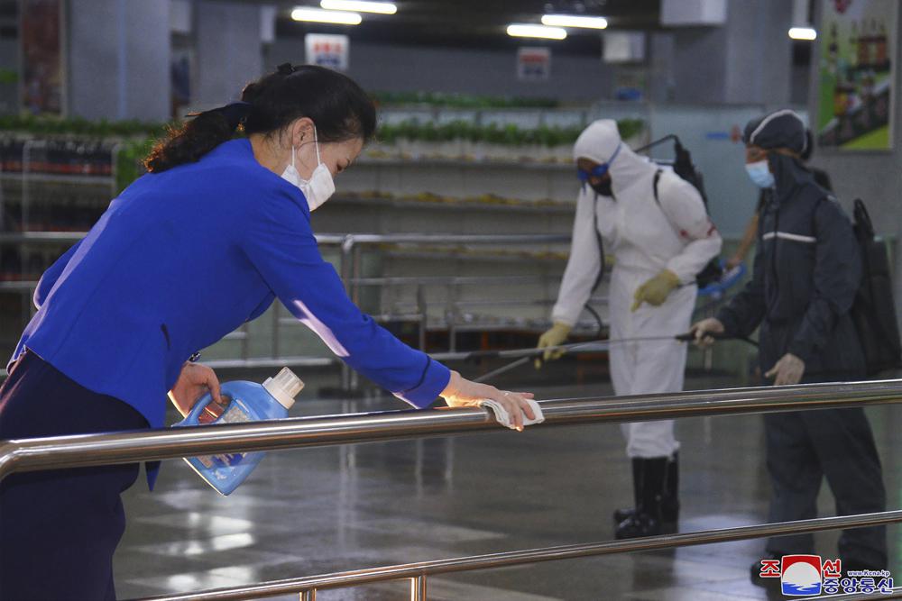 FILE – In this photo published on June 28, 2022 by the North Korean government, North Korean employees disinfect a facility at an underground store in Pyongyang, North Korea. Independent journalists were not given access to cover the event depicted in this image distributed by the North Korean government. The content of this image is as provided and cannot be independently verified. Korean language watermark on image as provided by source reads: “KCNA” which is the abbreviation for Korean Central News Agency. On Saturday, July 30, 2022, North Korea reported no new fever cases for the first time since it abruptly admitted to its first domestic COVID-19 outbreak and placed its 26 million people under more draconian restrictions in May. (Korean Central News Agency/Korea News Service via AP, File)