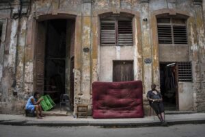 A woman selling avocados waits for customers in Havana, Cuba, Saturday, July 9, 2022. The inflation that followed the elimination of the country’s old dual-currency system — a long-discussed reform that finally arrived in the midst of other crises, has been a hard blow for many Cubans. While the newly unified peso officially trades at 24 to the dollar, prices on the street run at 100 to 1. (AP Photo/Ramon Espinosa)