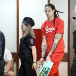 WNBA star and two-time Olympic gold medalist Brittney Griner is escorted to a courtroom for a hearing, in Khimki outside Moscow, Russia, Thursday, July 7, 2022. Griner on Thursday pleaded guilty to drug possession and smuggling during her trial in Moscow but said she had no intention of committing a crime, Russian news agencies reported. (AP Photo/Alexander Zemlianichenko)