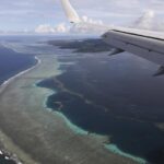 The aerial photo shows Pohnpei International Airport in Kolonia, Federated States of Micronesia, on Aug. 5, 2019. Micronesia has likely become the final nation in the world with a population of more than 100,000 to experience an outbreak of COVID-19. On Tuesday, July 19, 2022, the government announced it had become aware of multiple cases across two of the nation’s four states.(Jonathan Ernst/Pool Photo via AP, File)