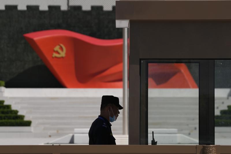 FILE – A security guard stands near a sculpture of the Chinese Communist Party flag at the Museum of the Communist Party of China on May 26, 2022, in Beijing. China said it was conducting military exercises Saturday, July 30, off its coast opposite Taiwan after warning Speaker Nancy Pelosi of the U.S. House of Representatives to scrap possible plans to visit the island democracy, which Beijing claims as part of its territory. (AP Photo/Ng Han Guan, File)