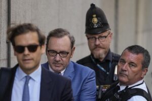 Actor Kevin Spacey, center, arrives at the Old Bailey, in London, Thursday, July 14, 2022. Spacey appeared Thursday in a court in London after he was charged with sexual offenses against three men. The 62-year-old Spacey is accused of four counts of sexual assault and one count of causing a person to engage in penetrative sexual activity without consent. (AP Photo/Frank Augstein)