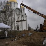 FILE – A crane lifts the corpse of a man from a mass grave to be identified in a morgue, in Bucha, on the outskirts of Kyiv, Ukraine, Sunday, April 10, 2022. Ministers from dozens of nations are meeting on Thursday, July 14, 2022 in the Netherlands to discuss with the International Criminal Court’s chief prosecutor how best to coordinate efforts to bring to justice perpetrators of war crimes in Ukraine. (AP Photo/Rodrigo Abd, File)