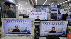 FILE – A man walks past TV monitors displaying a news program at an electronic shop in Seoul, South Korea, on Oct. 14, 2014, showing a North Korean newspaper with a photo of North Korean leader Kim Jong Un smiling, reportedly during his first public appearance in five weeks in Pyongyang, North Korea. The writing reads, “Honorable Kim Jong Un.” South Korea plans to lift its decades-long ban on public access to North Korean television, newspapers and other media as part of its efforts to promote mutual understanding between the rivals, officials said Friday, July 22, 2022, despite animosities over the North’s recent missile tests. (AP Photo/Ahn Young-joon, File)