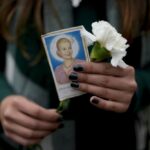 A woman holds a photo of Argentina’s late first lady Maria Eva Duarte de Peron, better known as Evita, as she waits her turn to visit Evita’s tomb in Buenos Aires, Argentina, Tuesday, July 26, 2022. Argentines commemorate the 70th anniversary of the death of their most famous first lady, who died of cancer on July 26, 1952 at the age of 33. (AP Photo/Natacha Pisarenko)