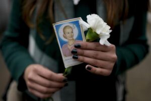 A woman holds a photo of Argentina’s late first lady Maria Eva Duarte de Peron, better known as Evita, as she waits her turn to visit Evita’s tomb in Buenos Aires, Argentina, Tuesday, July 26, 2022. Argentines commemorate the 70th anniversary of the death of their most famous first lady, who died of cancer on July 26, 1952 at the age of 33. (AP Photo/Natacha Pisarenko)