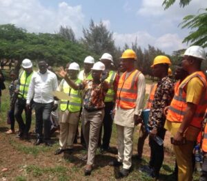 The consultant showing the Rector how the buildings will be positioned.