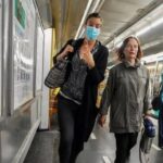 A woman wearing a face mask to protect against COVID-19 rushes on a subway platform in Paris, Thursday, June 30, 2022.   –   Copyright  Michel Euler/AP