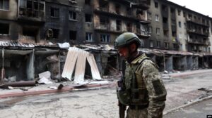 A Ukrainian serviceman passes destroyed buildings in the Ukrainian town of Siversk, Donetsk region, on July 22, 2022, amid the Russian invasion of Ukraine.