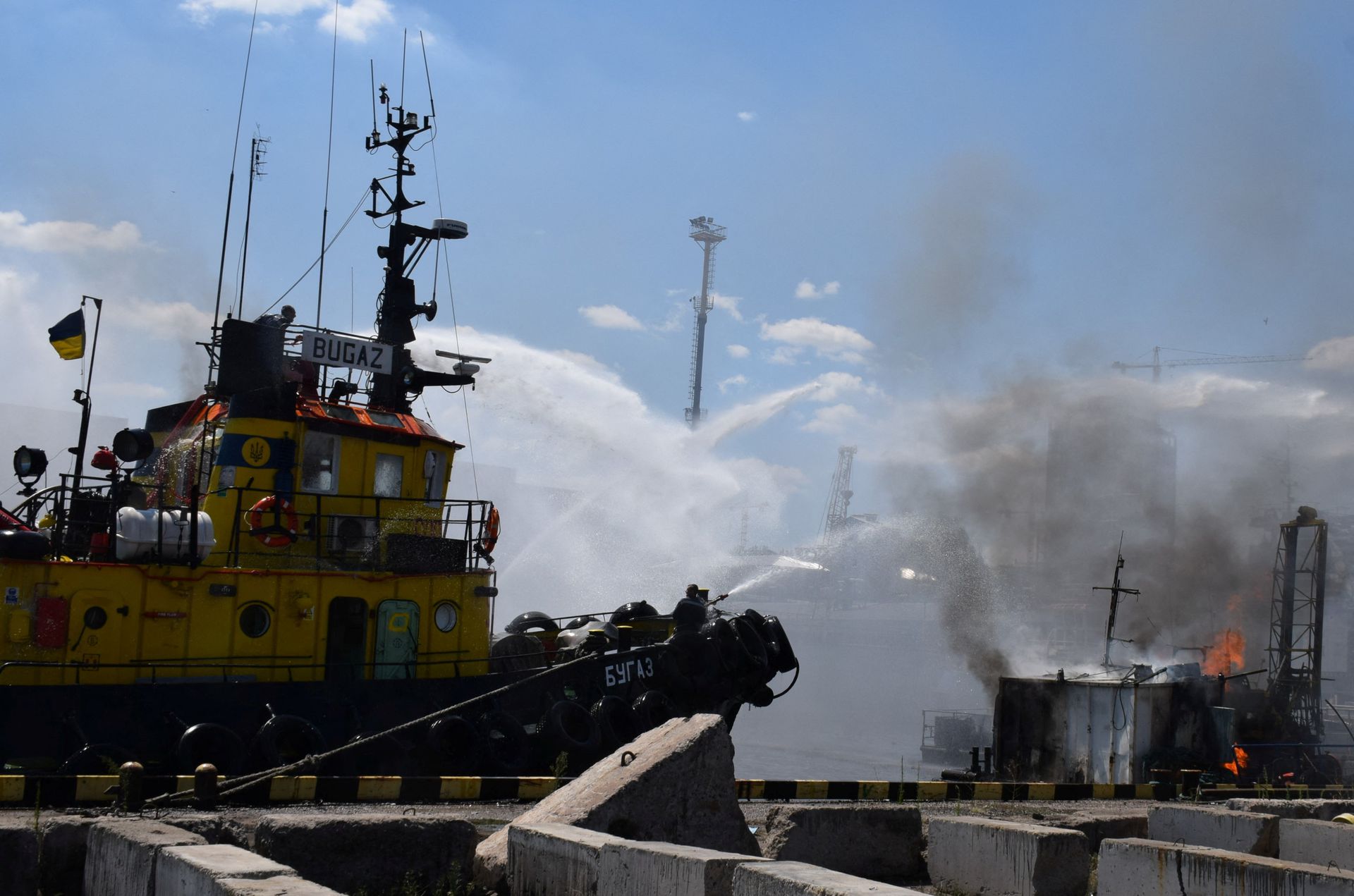 Firefighters work at a site of a Russian missile strike in a sea port of Odesa, as Russia’s attack on Ukraine continues, Ukraine July 23, 2022. Press service of the Joint Forces of the South Defence/Handout via REUTERS