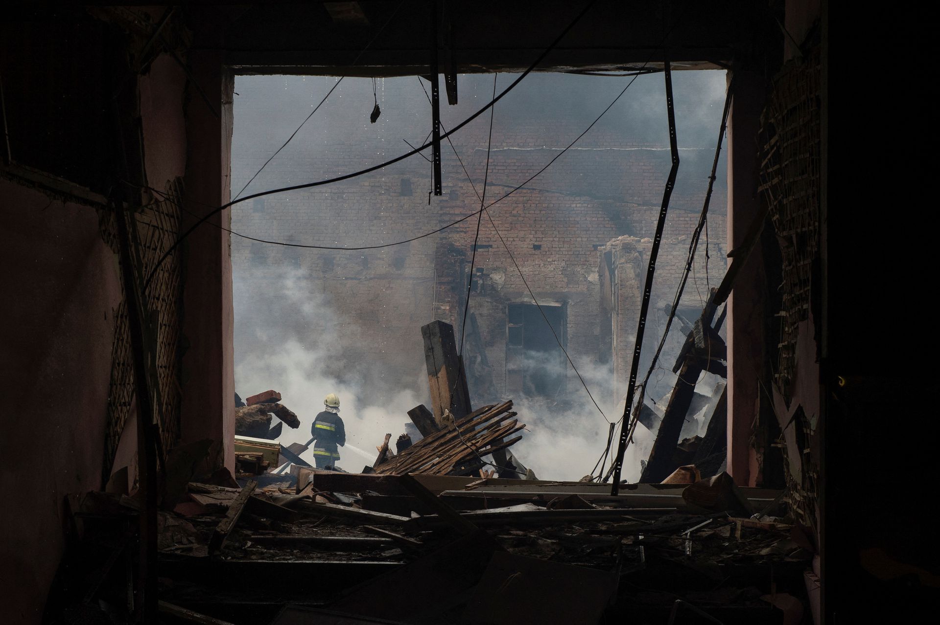A firefighter works at a site of a professional college that was heavily damaged by a Russian missile strike, as Russia’s attack on Ukraine continues, in Kharkiv, Ukraine July 30, 2022. REUTERS/Sofiia Gatilova