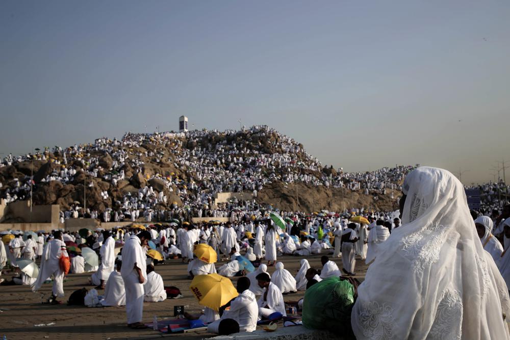 FILE – Muslim pilgrims pray on a rocky hill known as Mountain of Mercy, on the Plain of Arafat, during the annual hajj pilgrimage, near the holy city of Mecca, Saudi Arabia, on Sept. 11, 2016. Police in Mecca say they have arrested a Saudi man who helped an Israeli-Jewish reporter sneak into the city, defying a rule that only Muslims can enter the area that is home to Islam’s holiest site. (AP Photo/Nariman El-Mofty, File)