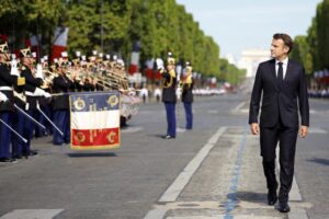 French President Emmanuel Macron reviews the troops during the annual Bastille Day military parade, in Paris, Thursday, July 14, 2022. France is celebrating its national holiday with thousands of French troops marching down the Champs-Elysees avenue alongside allies from Eastern Europe. (Sarah Meyssonnier, pool via AP)