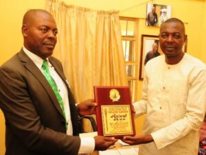 NYSC Coordinator, Kaduna State, Mr A O Oche (R) receiving the award plaque from Vice Secretary, LWF, Mr Abraham Ugwaje (L) in Kaduna