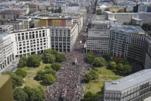 Revelers march down the Leipziger Strasse street on the Leipziger Platz square during the annual pride march in the German capital Berlin, Saturday, July 23, 2022. (AP Photo/Markus Schreiber)
