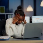 stressed-businesswoman-suffering-from-headache-work-doing-overtime-late-night-1024×576