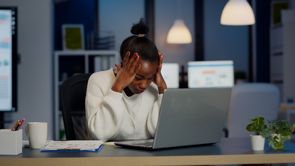 stressed-businesswoman-suffering-from-headache-work-doing-overtime-late-night-1024×576