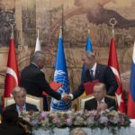 Turkish President Recep Tayyip Erdogan, right, and U.N. Secretary General, Antonio Guterres, sit as Sergei Shoigu, Russia’s Defense Minister, and Hulusi Akar, Turkey’s Defense Minister. shake hands during a signing ceremony at Dolmabahce Palace in Istanbul, Turkey, Friday, July 22, 2022. U.N. Secretary General Antonio Guterres and Turkish President Recep Tayyip Erdogan were due on Friday to oversee the signing of a key agreement that would allow Ukraine to resume its shipment of grain from the Black Sea to world markets and for Russia to export grain and fertilizers, ending a standoff that has threatened world food security. (AP Photo/Khalil Hamra)