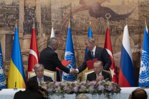 Turkish President Recep Tayyip Erdogan, right, and U.N. Secretary General, Antonio Guterres, sit as Sergei Shoigu, Russia’s Defense Minister, and Hulusi Akar, Turkey’s Defense Minister. shake hands during a signing ceremony at Dolmabahce Palace in Istanbul, Turkey, Friday, July 22, 2022. U.N. Secretary General Antonio Guterres and Turkish President Recep Tayyip Erdogan were due on Friday to oversee the signing of a key agreement that would allow Ukraine to resume its shipment of grain from the Black Sea to world markets and for Russia to export grain and fertilizers, ending a standoff that has threatened world food security. (AP Photo/Khalil Hamra)