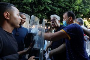 Hamma al-Hammami, a leftist activist and former political prisoner, confronts with police during a protest organized by Tunisian civil society groups against the President Kais Saied’s upcoming referendum on a new constitution in Tunis, Tunisia July 22, 2022. REUTERS/Zoubeir Souissi