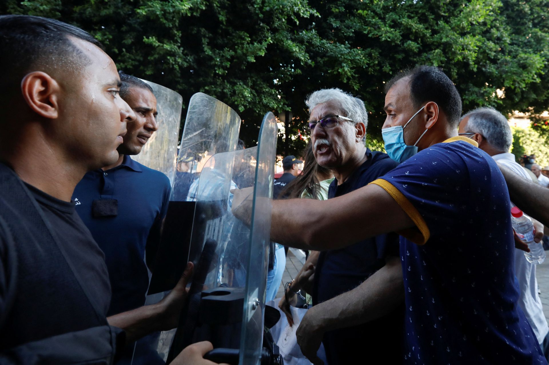 Hamma al-Hammami, a leftist activist and former political prisoner, confronts with police during a protest organized by Tunisian civil society groups against the President Kais Saied’s upcoming referendum on a new constitution in Tunis, Tunisia July 22, 2022. REUTERS/Zoubeir Souissi