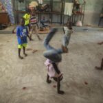 Children play in a school turned into a shelter after they were forced to leave their homes in Cite Soleil due to clashes between armed gangs, in Port-au-Prince, Haiti, Saturday, July 23, 2022. (AP Photo/Odelyn Joseph)