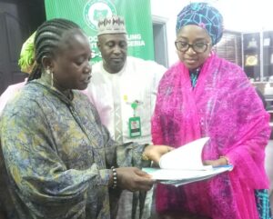 CS-SUNN Coordinator Jessica Bartholomew (L) presenting information, education and communication materials to Commissioner, Umma Aboki (R) in her office on Tuesday