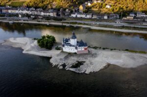 Pfalzgrafenstein castle is pictured in the middle of the river Rhine in Kaub, Germany, Friday, Aug. 12, 2022. The Rhine carries low water after a long drought period. (AP Photo/Michael Probst)