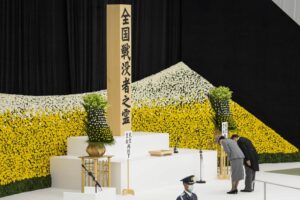 Japan’s Emperor Naruhito and Empress Masako bow as they attend a memorial service marking the 77th anniversary of Japan’s World War II defeat, at the Nippon Budokan hall in Tokyo, Monday, Aug. 15, 2022. (Yuichi Yamazaki/Pool Photo via AP)