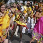 Performers dance during the Family Day at the Notting Hill Carnival in London, Sunday Aug. 28, 2022. The Carnival returned to the streets for the first time in two years, after it was thwarted by the pandemic. (Victoria Jones/PA via AP)