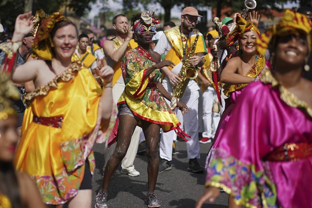 Performers dance during the Family Day at the Notting Hill Carnival in London, Sunday Aug. 28, 2022. The Carnival returned to the streets for the first time in two years, after it was thwarted by the pandemic. (Victoria Jones/PA via AP)