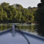 In this July 22, 2019 photo provided by Rodrigo Vargas, a boat moves through the in Cristalino II State Park in the state of Mato Grosso, in Brazil. In a move that shocked environmentalists, the government of Brazil’s third-largest state gave up on a legal battle to protect the state park located in one of the Amazon’s most biodiverse areas. Now the park will be officially dissolved, its press office confirmed to The Associated Press. (Rodrigo Vargas via AP)