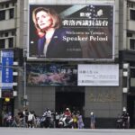 FILE – People walk past a billboard welcoming U.S. House Speaker Nancy Pelosi, in Taipei, Taiwan, Aug 3, 2022. Days after Ayman al-Zawahiri was killed in Kabul, China staged large-scale military exercises and threatened to cut off contacts with the U.S. over House Speaker Nancy Pelosi’s visit to Taiwan. (AP Photo/Chiang Ying-ying, File)
