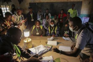 Election officials start to count the votes at a polling station in Eldoret, Kenya, Tuesday Aug. 9, 2022. Polls opened Tuesday in Kenya’s unusual presidential election, where a longtime opposition leader who is backed by the outgoing president faces the deputy president who styles himself as the outsider. (AP Photo/Brian Inganga)