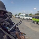 In this image made from video, Rwandan police patrol a road in Palma, Cabo Delgado province, Mozambique, Sunday Aug. 15, 2021. A new offensive by Mozambique’s Islamic extremist rebels in Cabo Delgado has increased the number of displaced by 80,000 and undermines the government’s claims of containing the insurgency. (AP Photo/Marc Hoogsteyns)